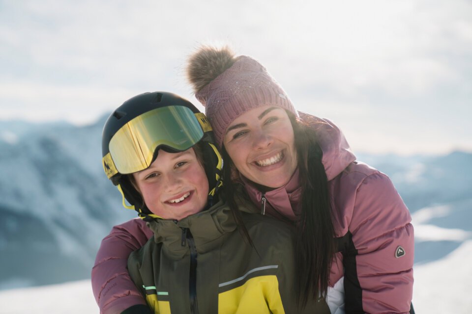 © INTERSPORT International Corporation GmbH Mutter und Kind beim Skifahren umarmen sich | © INTERSPORT International Corporation GmbH