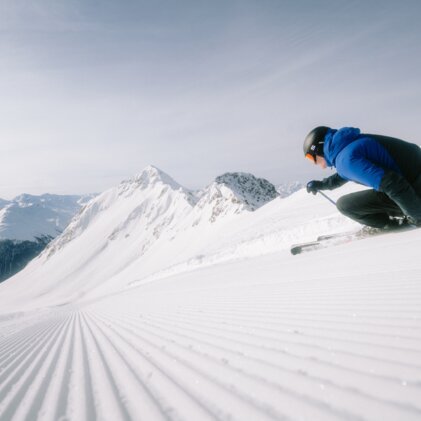 Skifahrer auf präparierter Piste in den Bergen