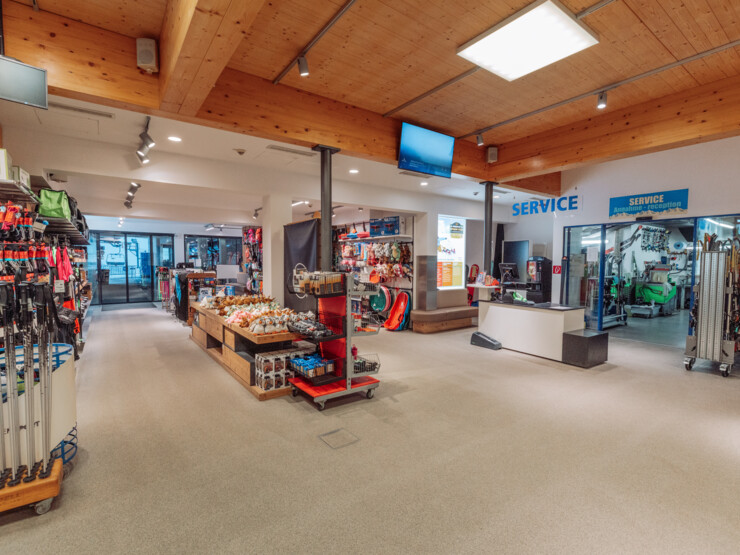 Interior of a sports shop with service area, retail displays and equipment for winter sports activities